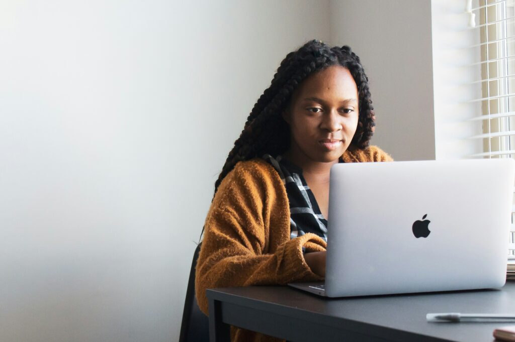 A person working on a laptop at home, representing online earning opportunities.