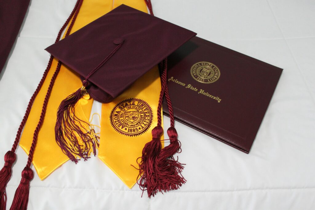 A graduation cap and books representing scholarships for international students.