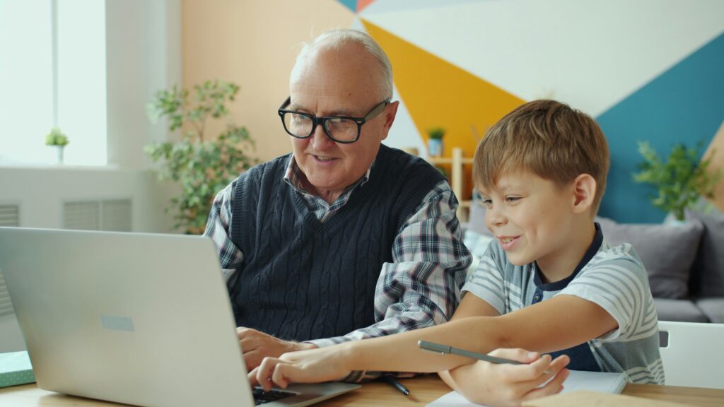 A family reviewing a health insurance plan on a laptop with an insurance card nearby.